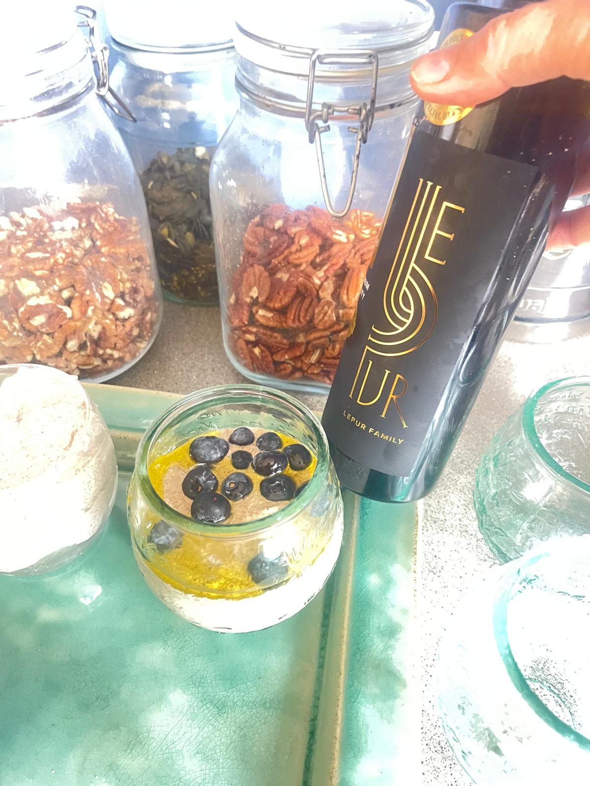 Healthy breakfast shot with Lepur extra virgin olive oil, chia seeds, blueberries, and yogurt in glass jar